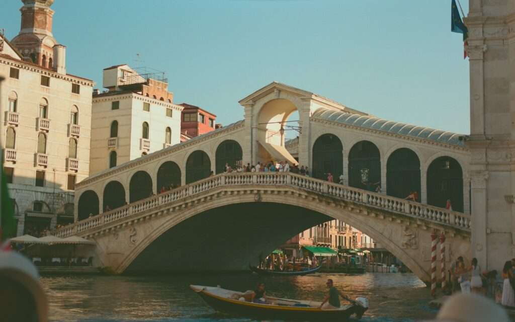 The Rialto Bridge spanning the Grand Canal in warm afternoon light